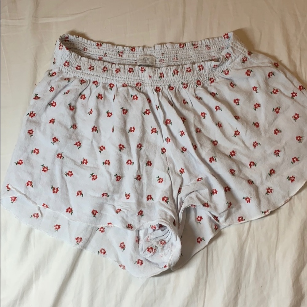 packing white and red floral shorts